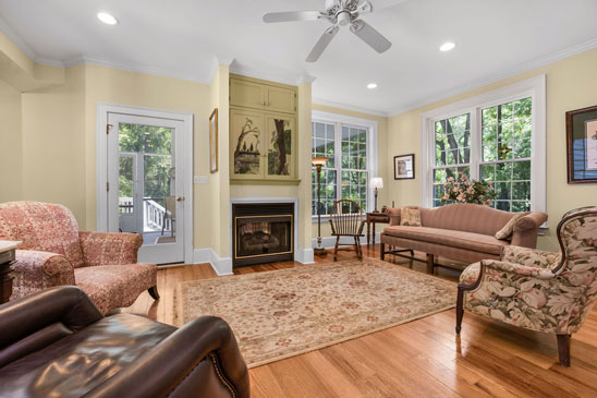 Family room at 3665 Old River Trail in Powhatan VA with large windows, gas fireplace, and garden views