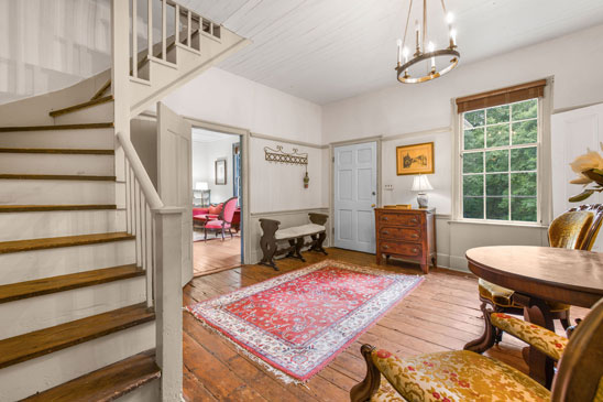 Entry hall at 3665 Old River Trail Powhatan VA with wide-plank pine floors and classic staircase