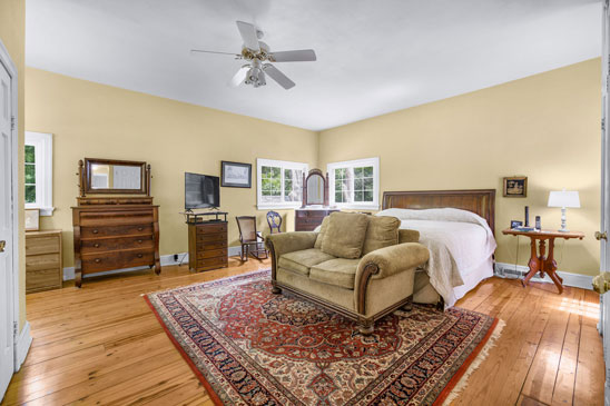 Primary bedroom at Pleasant Oak in Powhatan VA with heart pine floors and garden access