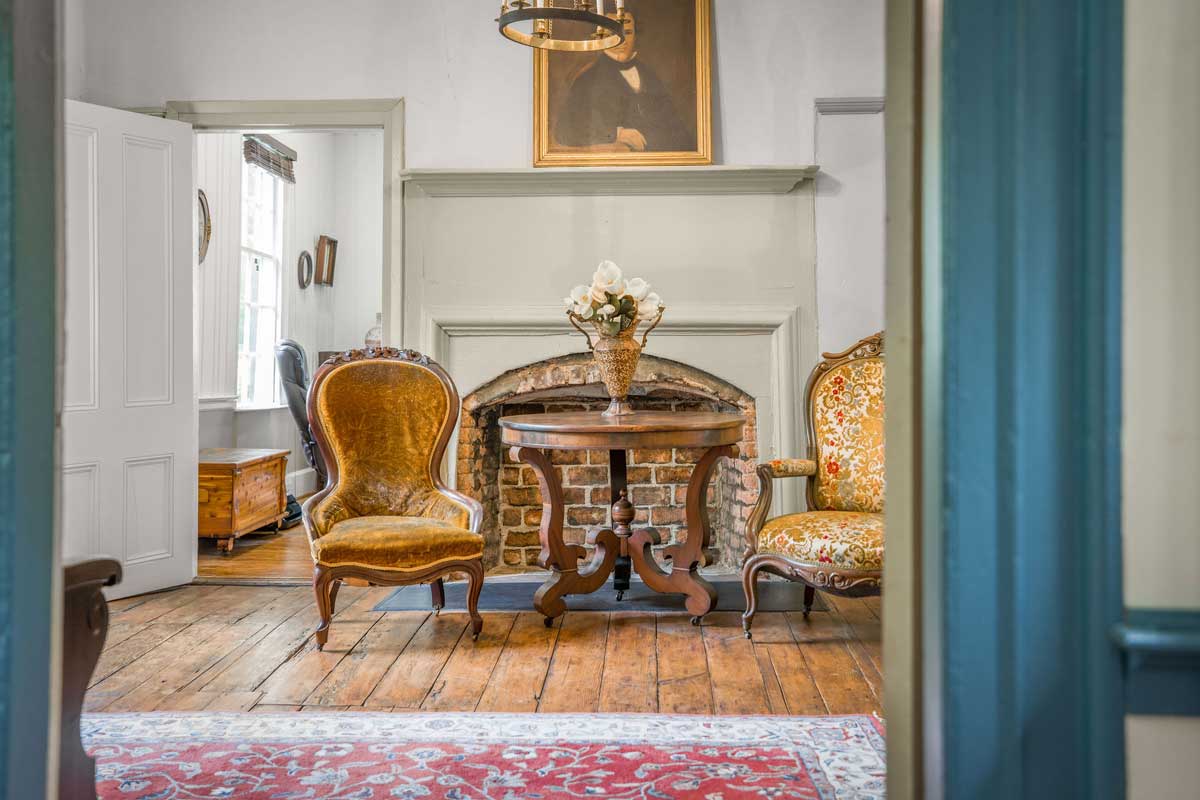 Original pine flooring and early staircase in the entrance hall at Pleasant Oak
